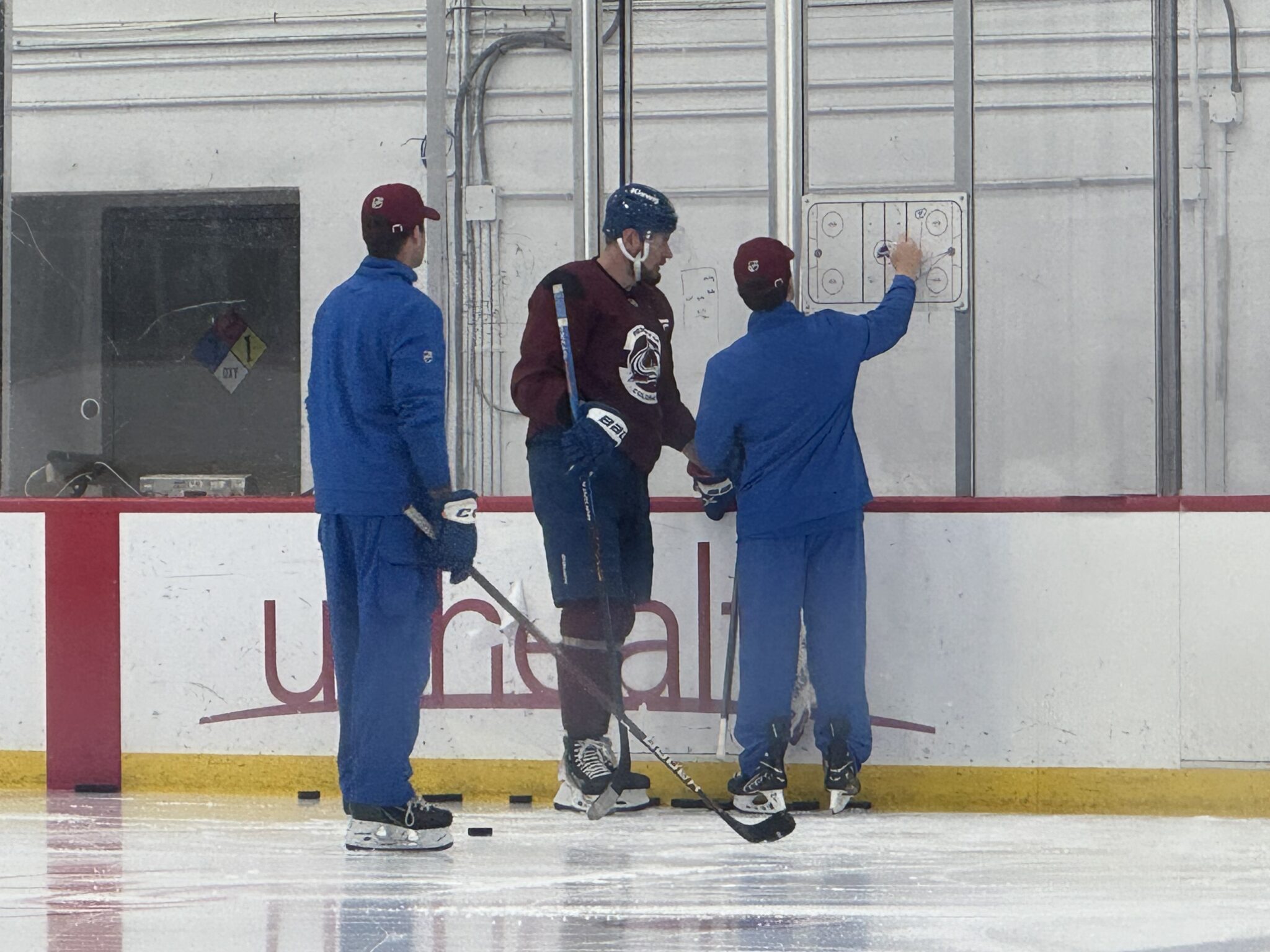 Colorado Avalanche forward Valeri Nichushkin works with skills coach Toby Petersen after the team finished practice and left the ice.